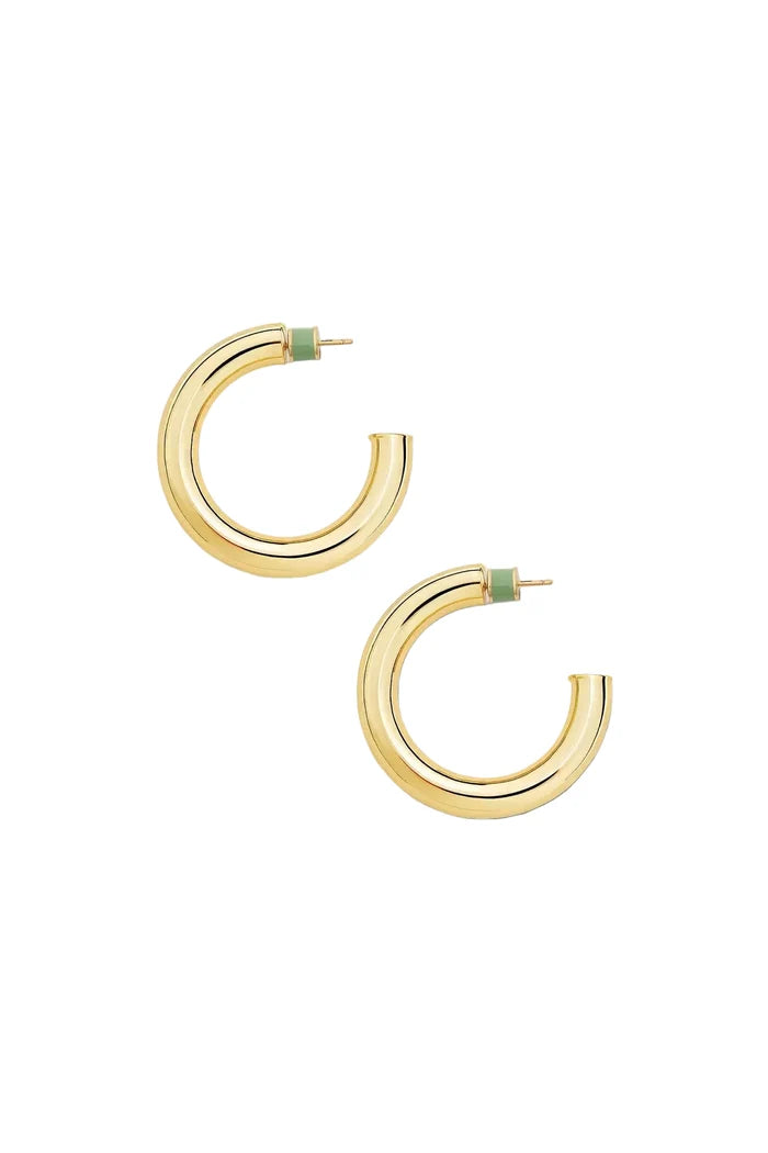 A pair of gold hoop earrings with a small light green enamel accent at the back, displayed on a clean off-white background.