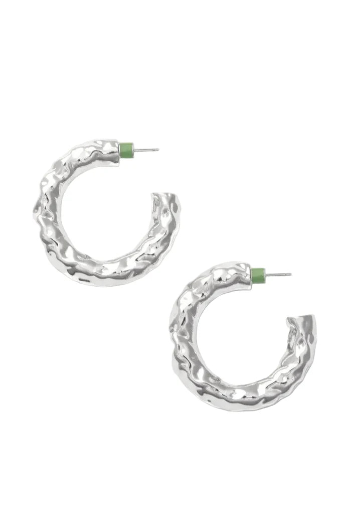 Silver textured hoop earrings on a white background