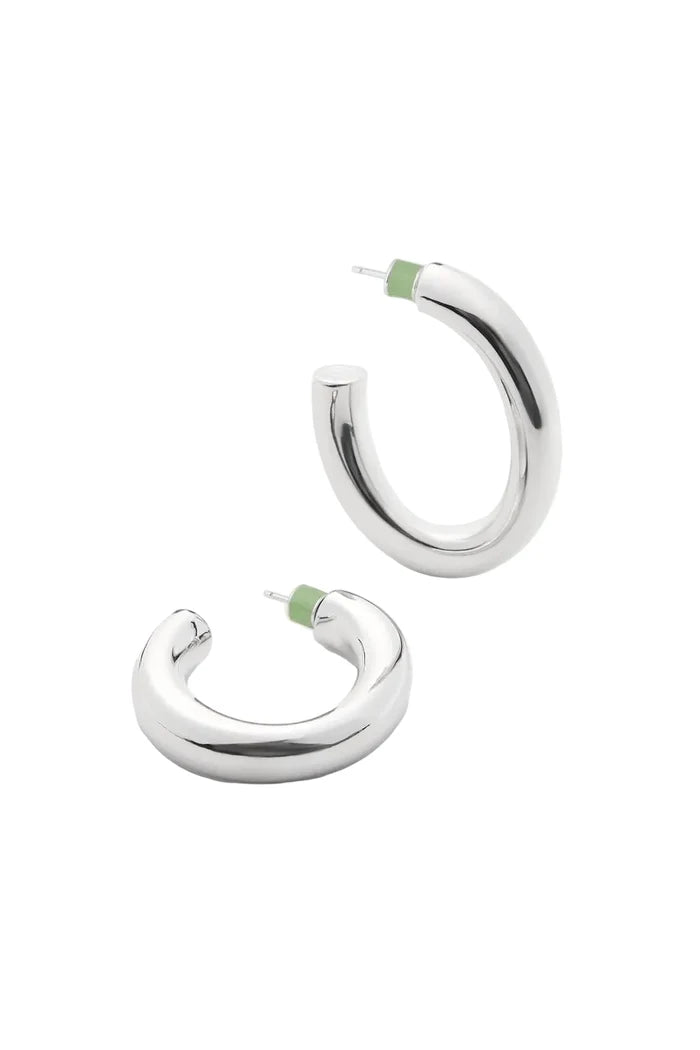 Pair of silver oval hoop earrings with green backs on a white background