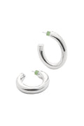 Pair of silver oval hoop earrings with green backs on a white background