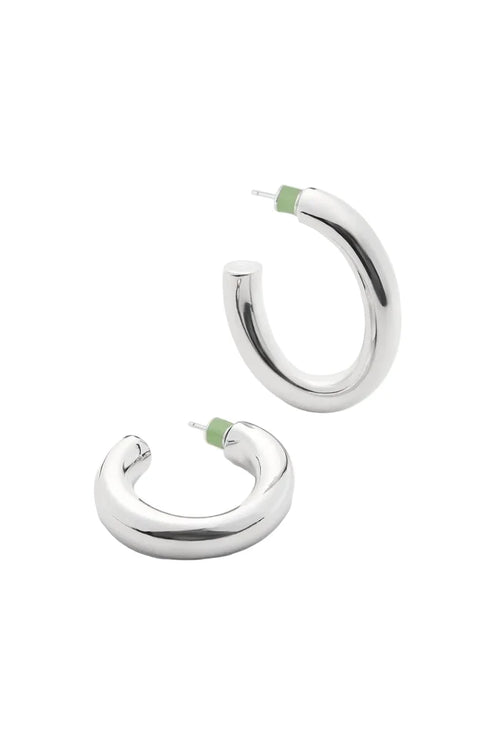 Pair of silver oval hoop earrings with green backs on a white background