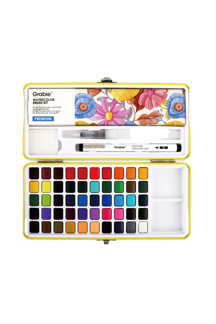 Grable Watercolor Brush set in a yellow metal case, shown open with multiple watercolor paint pans, a brush, and a marker on a white background.