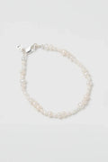 Pearl bracelet on a light gray background