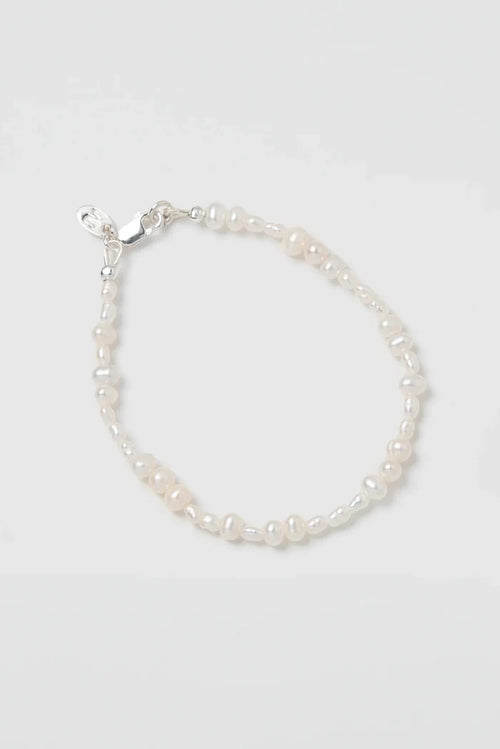 Pearl bracelet on a light gray background