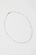 Pearl necklace on a light gray background