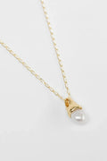 Gold necklace with a pearl pendant on a white background