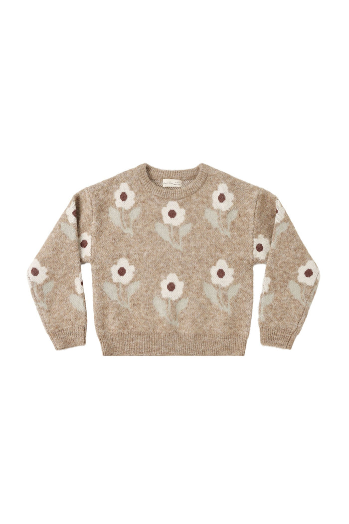 A beige knit crewneck sweater featuring a repeating pattern of stylized white flowers with brown centers and muted green stems, displayed flat against a solid white background.