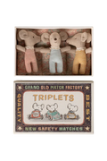 Three small mouse toys in a matchbox with a vintage-style label.