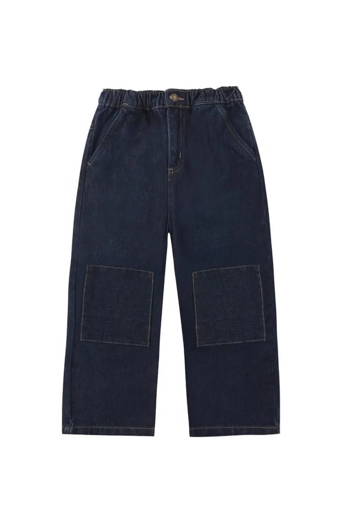 Dark indigo denim cropped pants with an elastic waistband and two large patch pockets on the front, shown flat on a light gray background.
