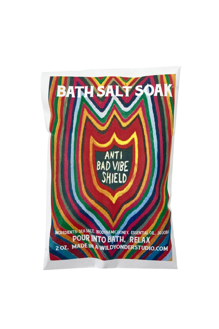 A 2 oz bag of 'Anti Bad Vibe Shield' bath salt soak by Wildonder Studio, featuring a vibrant, multicolored retro wavy pattern on a white background.