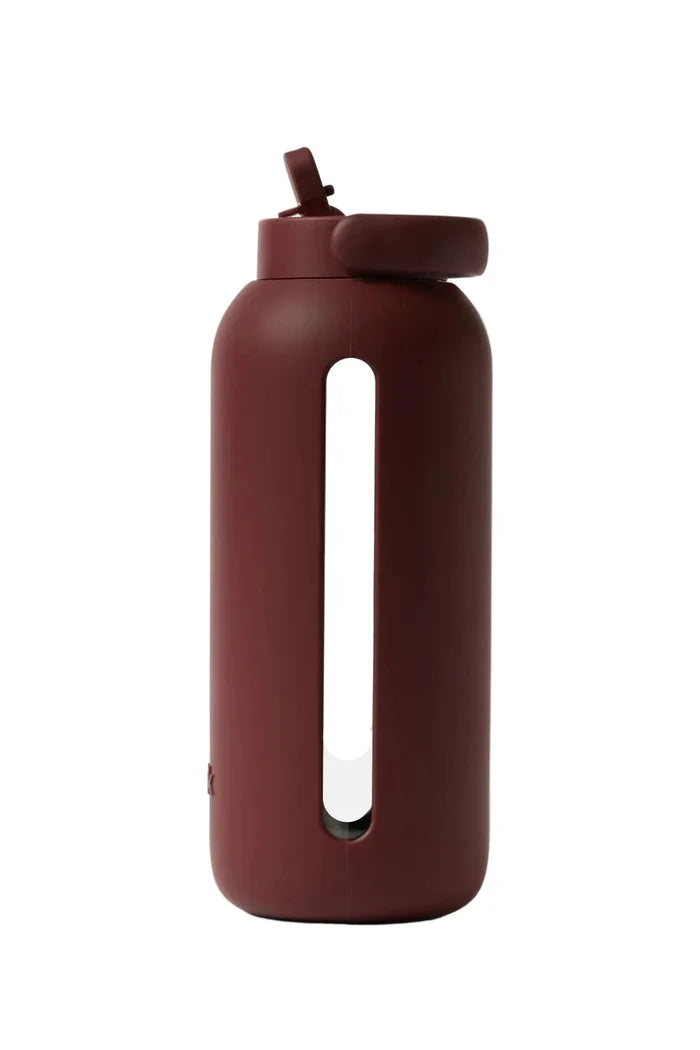 Maroon water bottle with a straw lid on a white background