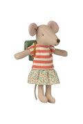 Stuffed mouse toy wearing a striped shirt and floral skirt on a white background