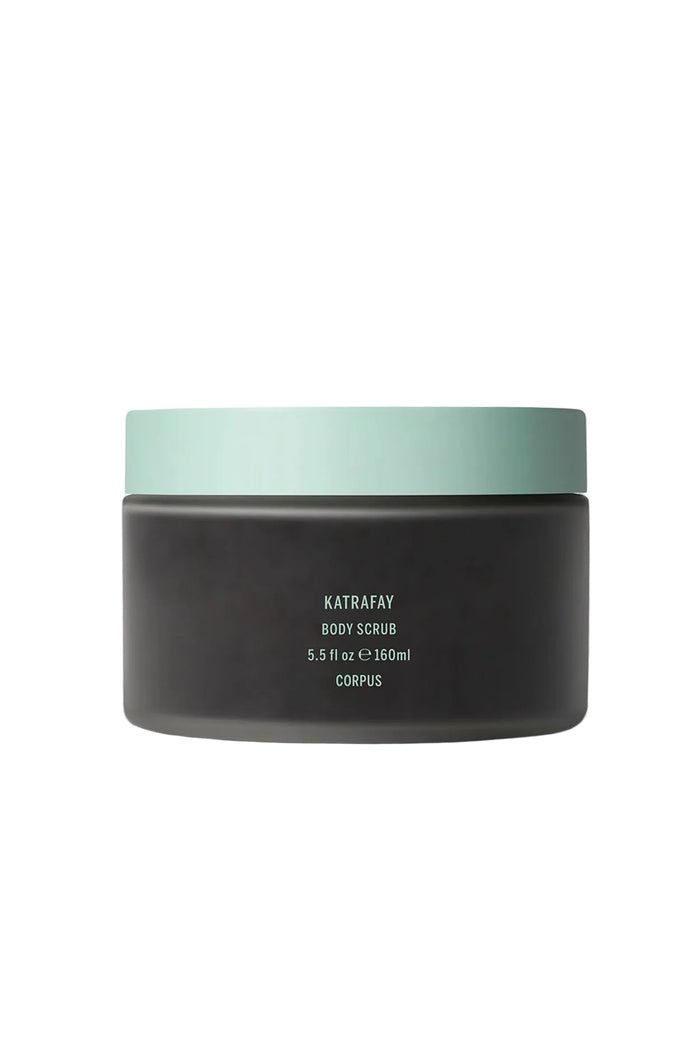 A jar of 'Katrafay Body Scrub' by Corpus, with a dark label and a green lid, indicating it is a body care product.