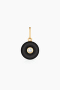 Black pendant with an inset gem on a white background