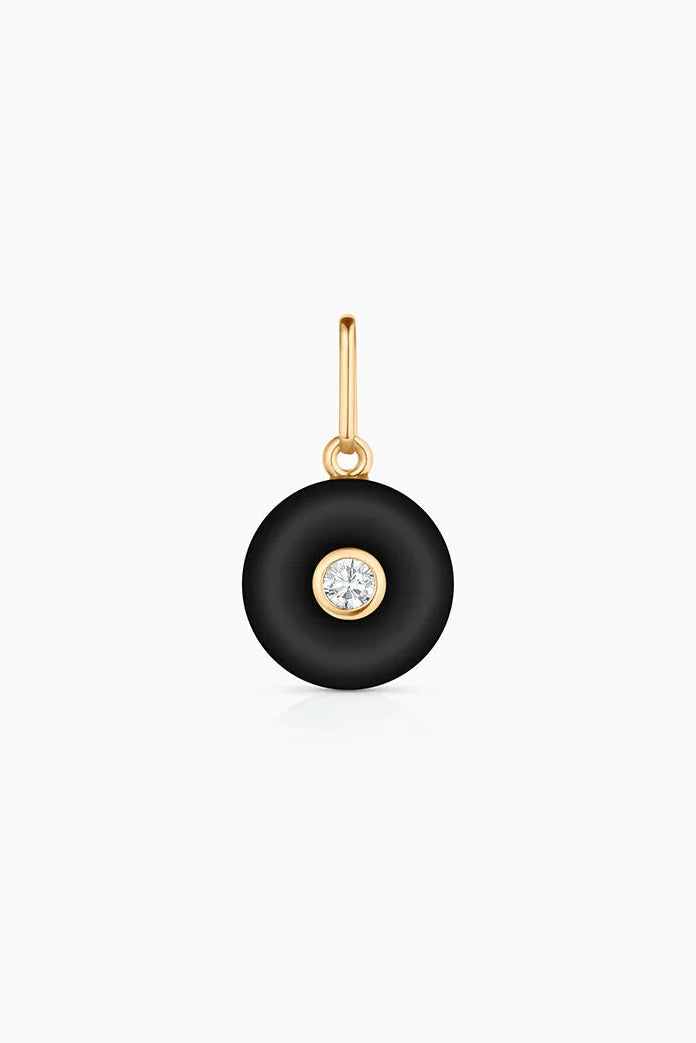 Black pendant with an inset gem on a white background