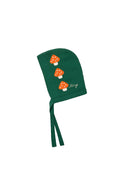 A dark green baby bonnet with three embroidered orange and white mushrooms and the brand name 'Tiny' embroidered in white script.