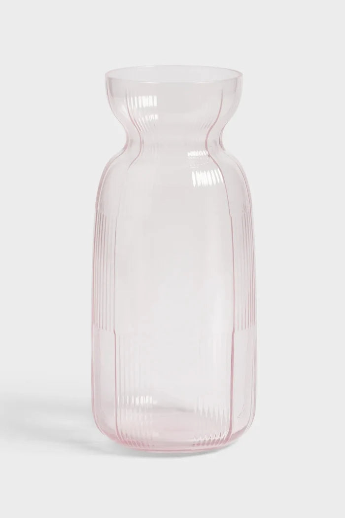 Pink glass carafe on white background