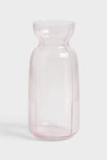 Pink glass carafe on white background
