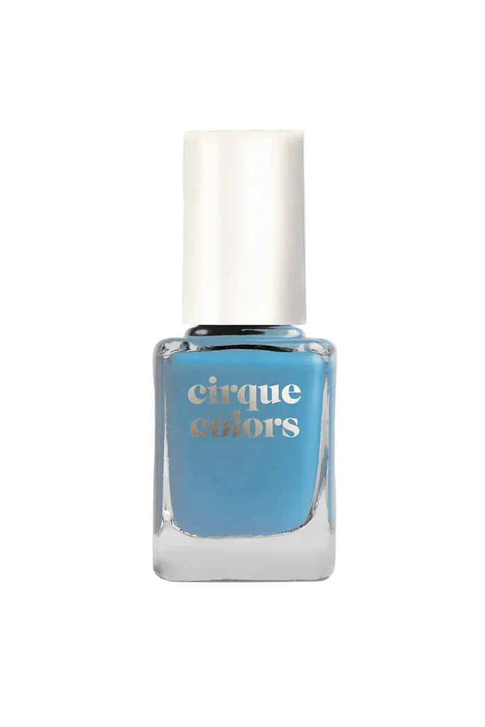 Blue nail polish bottle with 'cirque colors' branding on a light gray background