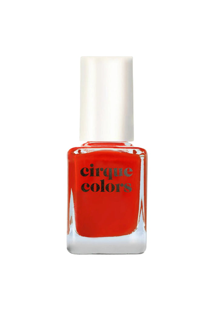 A bottle of red creme nail polish labeled 'Cirque Colors'.