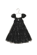 Black sparkly dress on a beige background