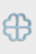 Clover shaped ceramic trivet on white background