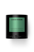 A black cylindrical candle jar with a green label reading 'COCO HINOKI' and embossed 'Boy Smells' at the bottom, centered on a white background.