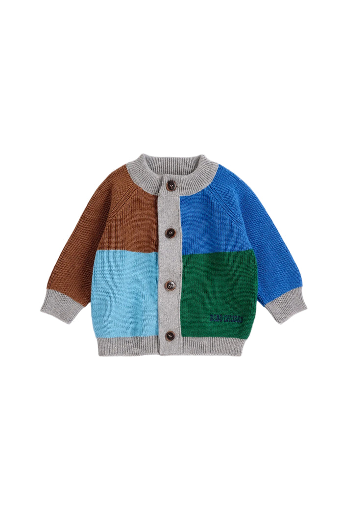 A baby knit cardigan sweater with a color-blocked design featuring brown, light blue, green, and royal blue panels, gray ribbed trim, and three brown buttons, shown on a plain light gray background.