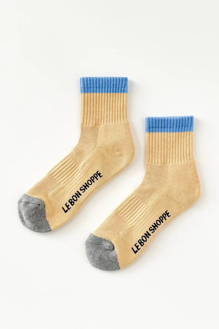 Yellow socks with blue tops and gray toes, featuring 'Le Bon Shoppe' branding on a white background.
