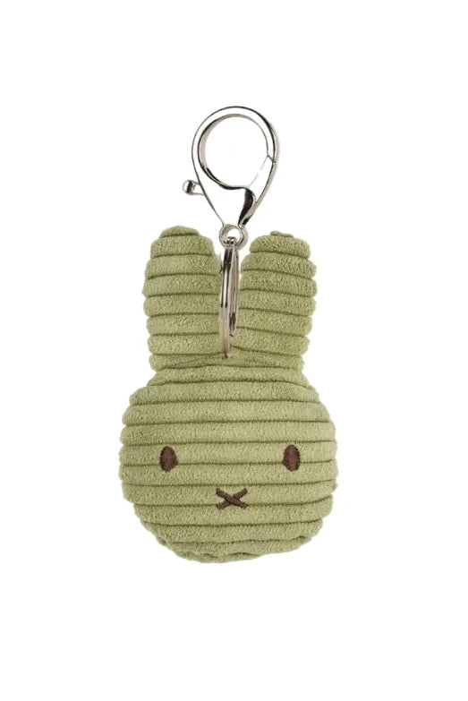 A small plush bunny keychain in light olive green corduroy fabric with embroidered facial features and a silver metal clasp, shown on a plain white background.