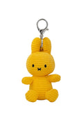 A yellow corduroy bunny keychain charm with a silver metal clasp, shown against a plain white background.