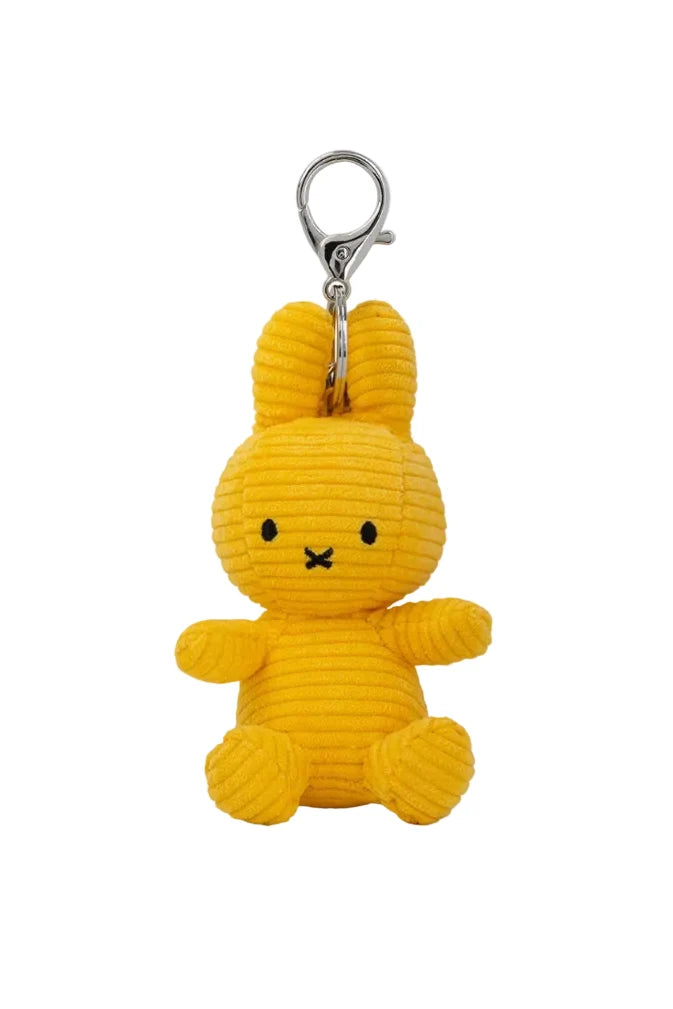 A yellow corduroy bunny keychain charm with a silver metal clasp, shown against a plain white background.