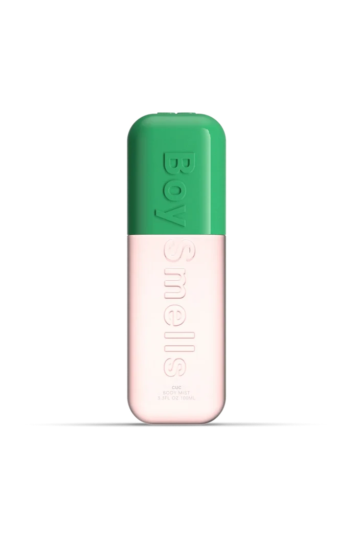 Two-tone green and pink cylindrical product with 'Boy Smells' branding on a white background