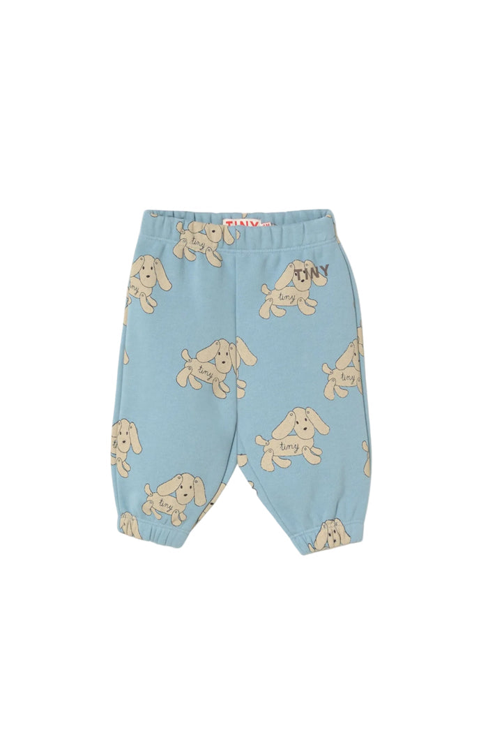 Light blue baby pants with an all-over beige puppy print, featuring an elastic waistband and leg cuffs, shown against a plain off-white background.