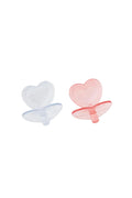 Two heart-shaped pacifiers, one clear and one pink, on a white background.