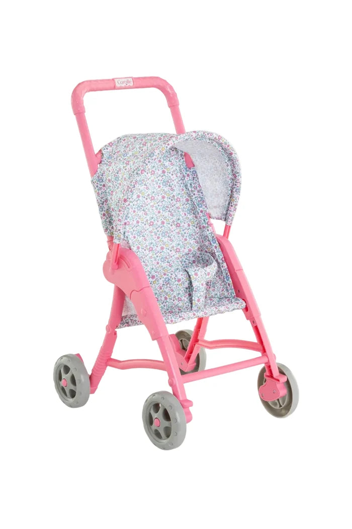 A pink toy doll stroller with a floral patterned fabric seat and canopy, featuring gray wheels and a small brand label on the handle.