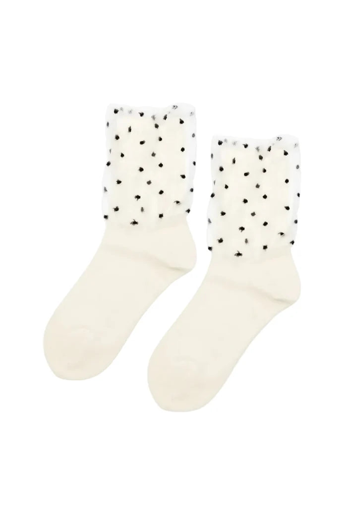 A pair of off-white crew socks with sheer white tulle cuffs decorated with small black polka dots, shown against a plain white background.