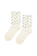A pair of off-white crew socks with sheer white tulle cuffs decorated with small black polka dots, shown against a plain white background.