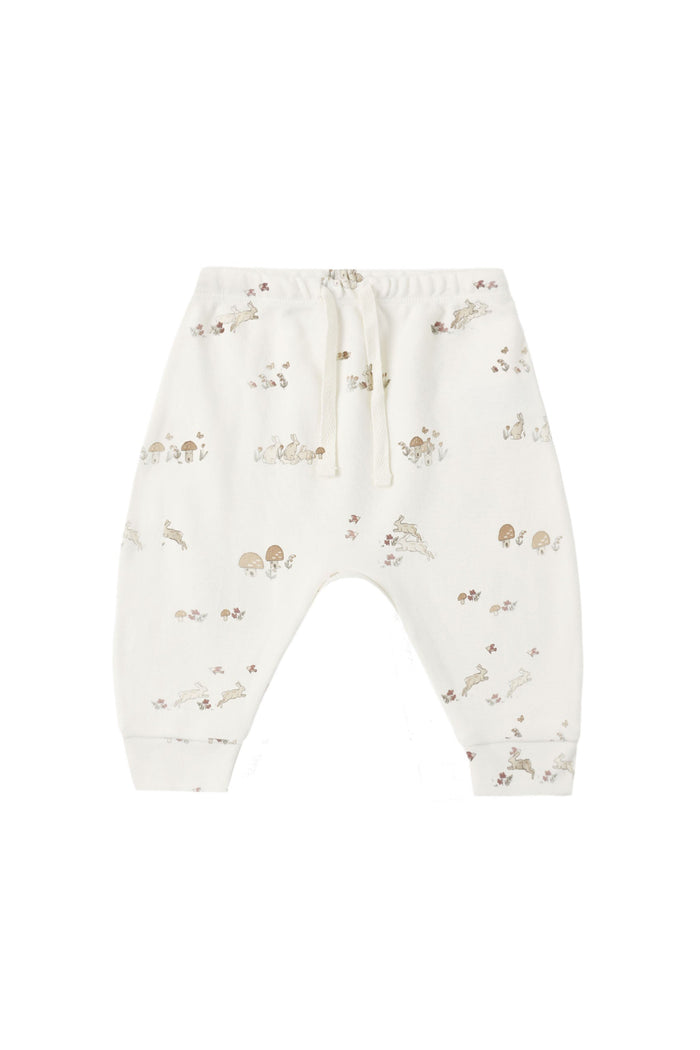 White baby pants with a small brown and beige animal print, featuring an elastic waistband and drawstring.