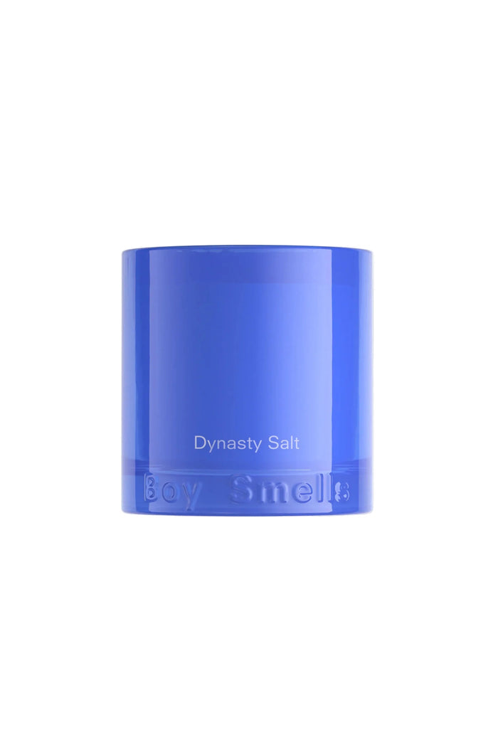 A blue candle with the label 'Dynasty Salt' on its side, against a white background.
