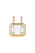 A gold pendant featuring a large rectangular clear baguette-cut gemstone in a gold bezel setting with two small gold loops at the top, shown on a clean white background.