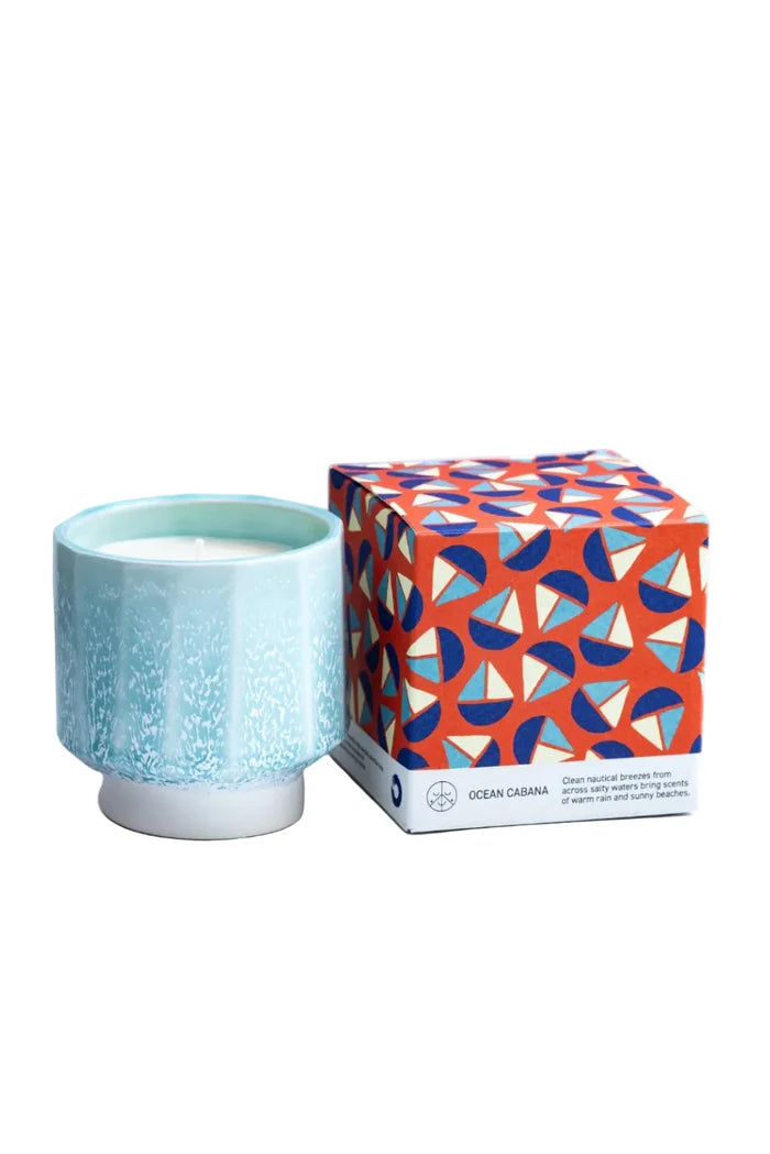 Light blue ceramic candle with a patterned box on a white background