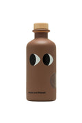 A bottle of extra virgin olive oil with black truffle flavor, branded Yiayia and Friends.