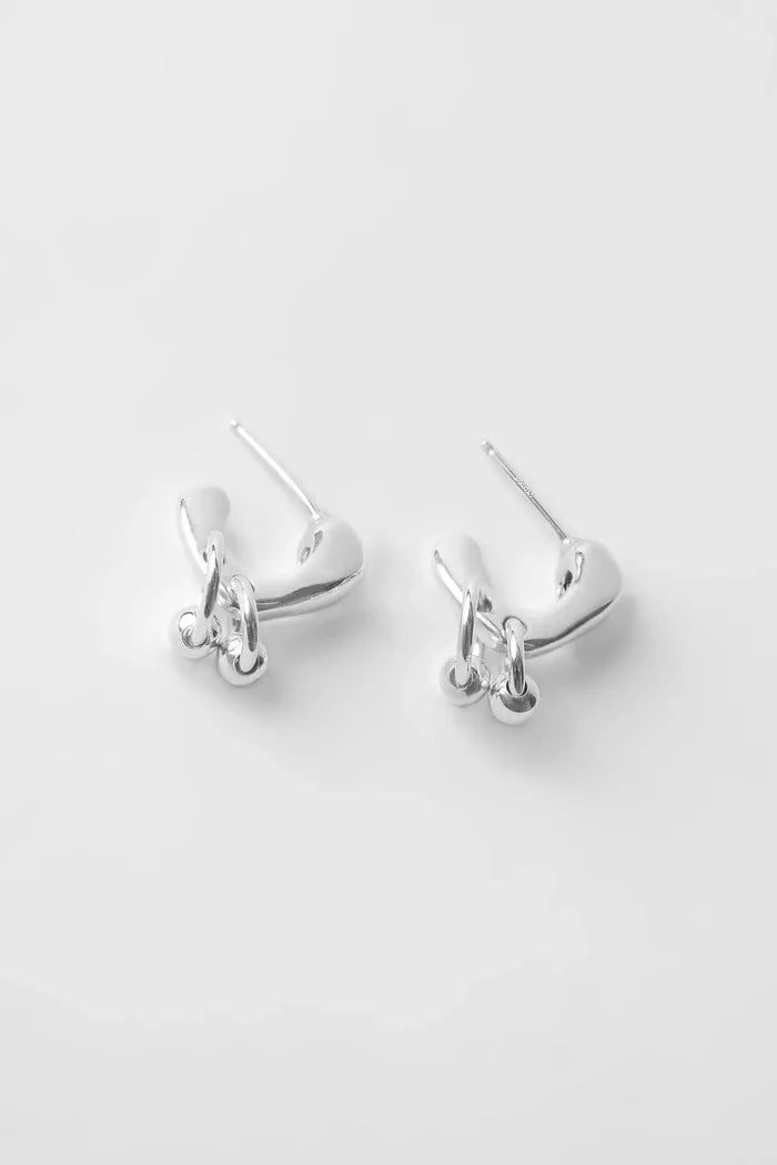 Pair of silver hoop earrings on a light gray background