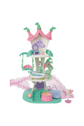 A pink and green fairy-themed castle playset with a small fairy figurine, set against a plain white background.