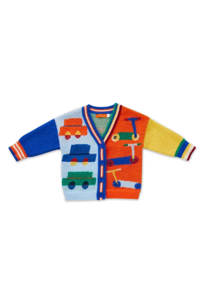 A colorful children's cardigan sweater with a playful toy-themed knit pattern, featuring blue and orange body panels with multicolored car graphics, striped cuffs, and a striped V-neck trim.