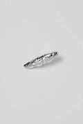 Silver hair clip with a textured design on a light gray background