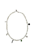 Pearl necklace with bead charms on white background