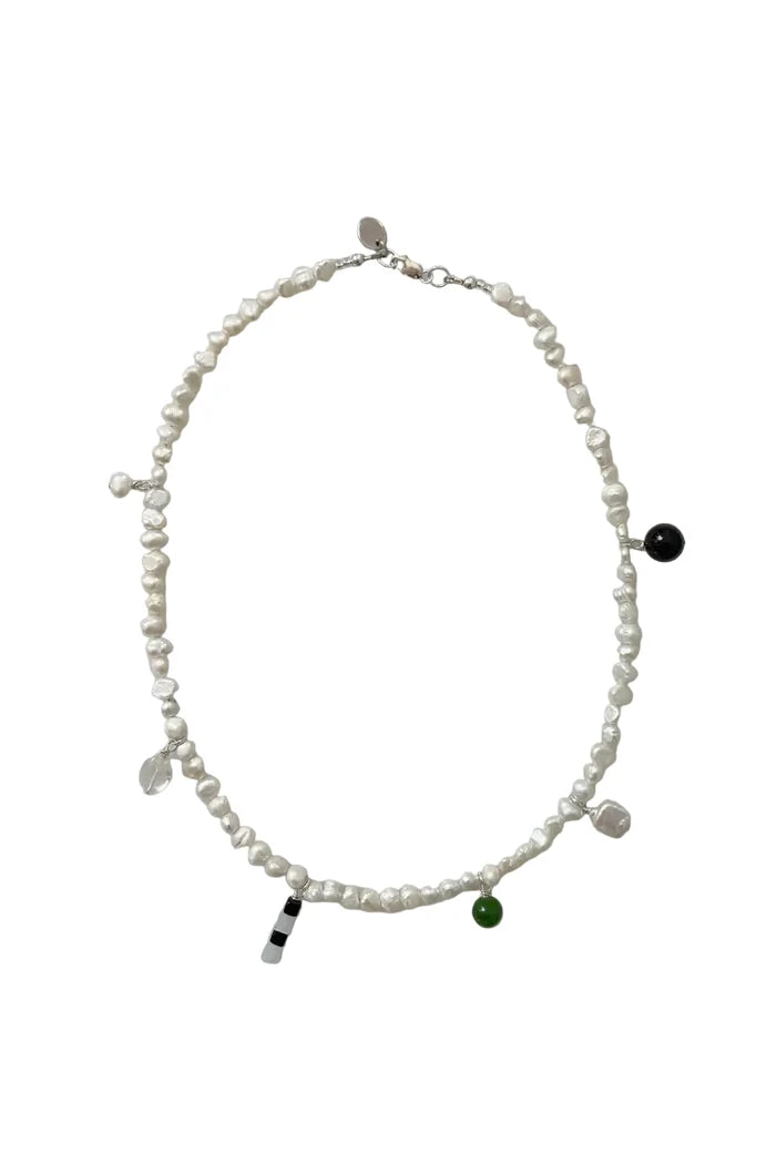 Pearl necklace with bead charms on white background