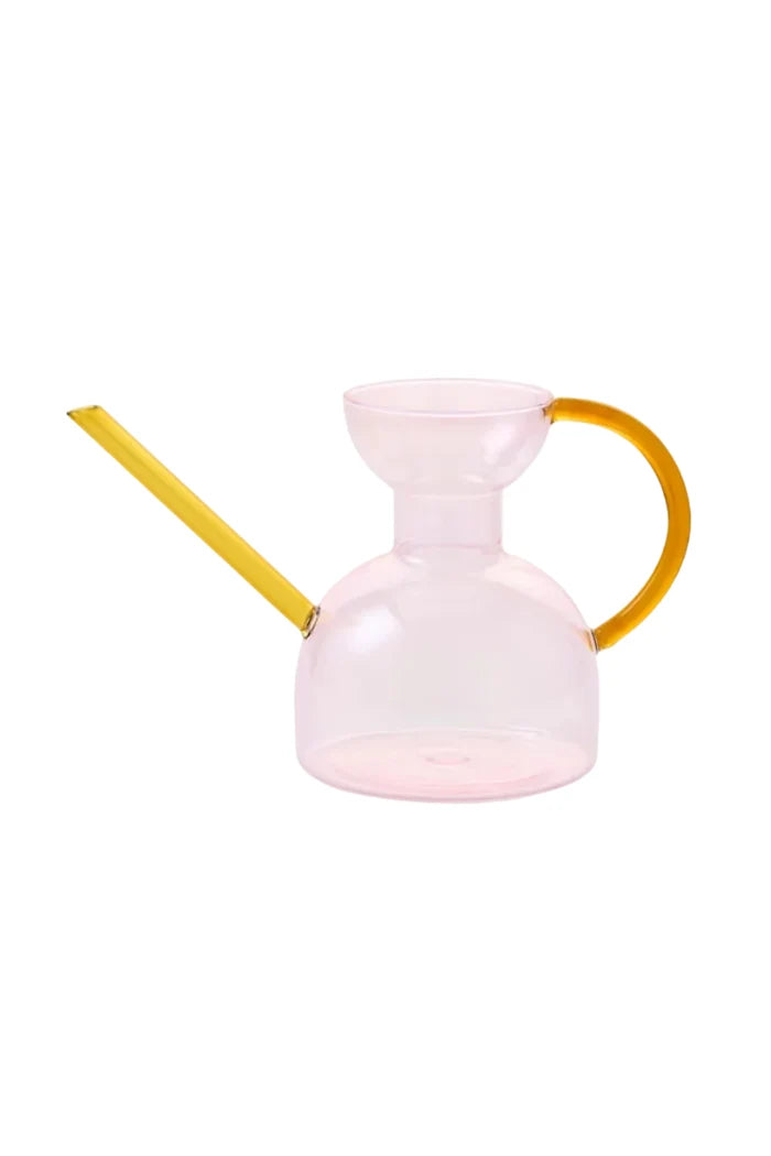 Pink watering can with a yellow handle and spout on a white background